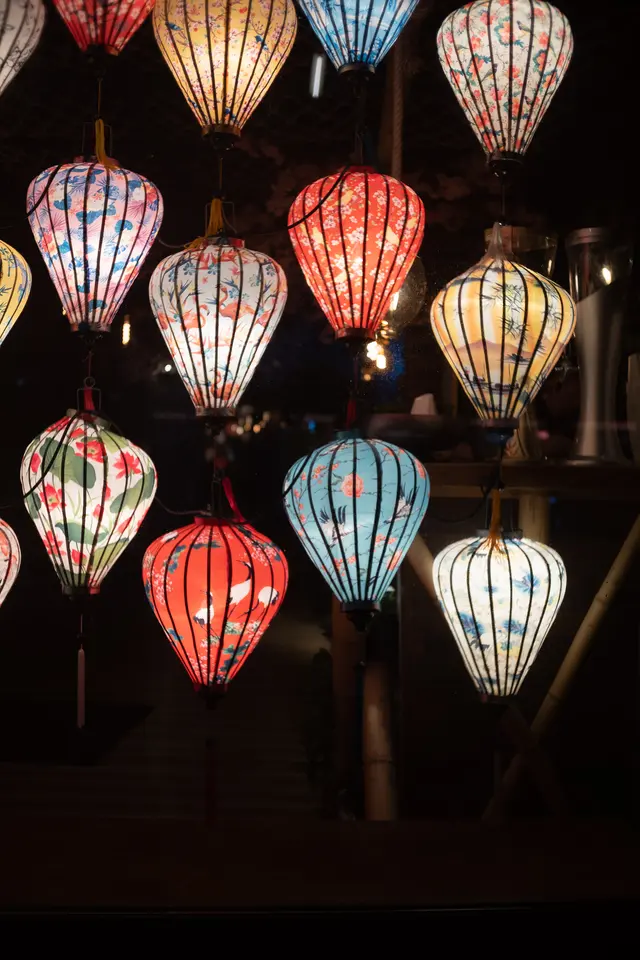 Painted paper lanterns glowing against the dark